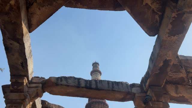 Qutb Minar Framed by Ancient Ruins in Delhi Skyline