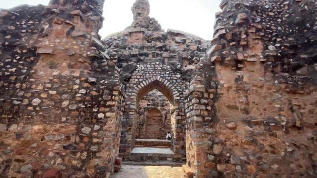 Exploring Ancient Stone Archway at Historic Ruins