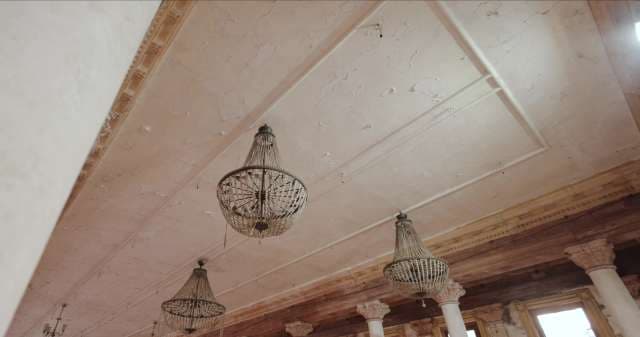 Elegant Chandeliers in Historic Interior With Ornate Columns