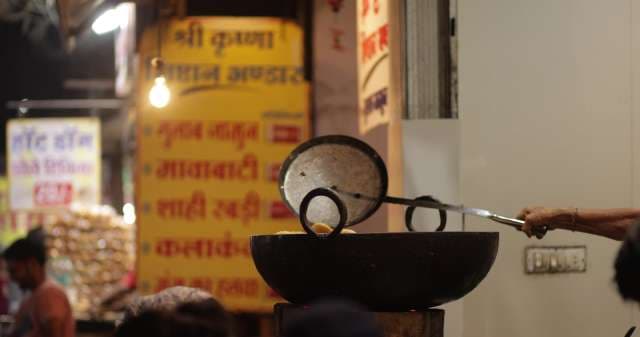 Street Vendor Frying Indian Snacks at the Sarafa Night Market, Indore