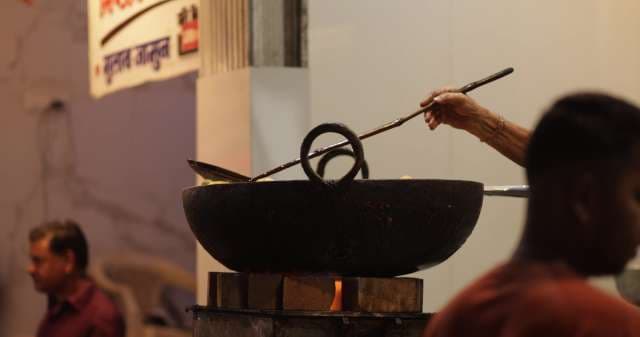 Indore Street Vendor Frying Traditional Indian Snacks in Large Kadai