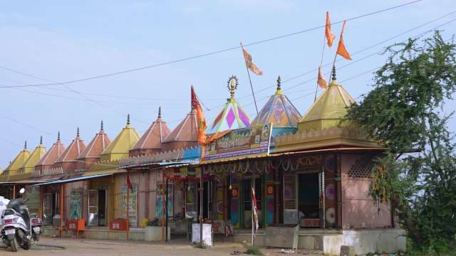 Colorful Hindu Temple with Ornate Domes and Flags in India