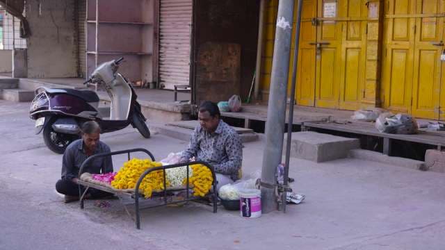 Street Flower Vendors Arranging Fresh Marigold Garlands