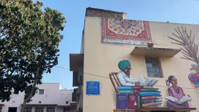 Vibrant Mural of Punjabi Man and Girl Reading in Ludhiana