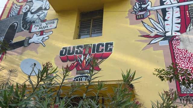 Justice-Themed Urban Mural Art on Building Wall