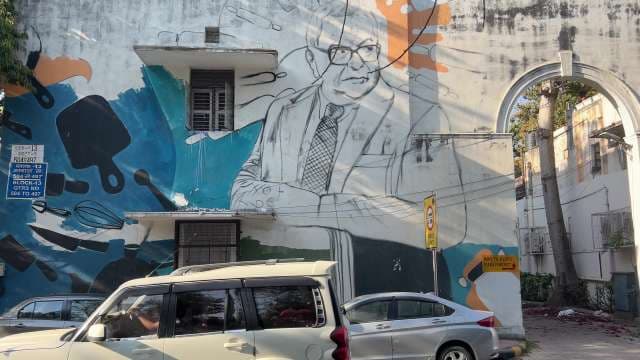 Colorful Urban Mural of Man With Kitchen Utensils in Delhi