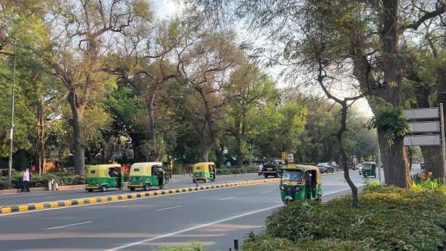 Busy Street With Green and Yellow Auto Rickshaws in Delhi