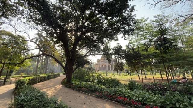 Serene Garden Pathway With Historic Monument View