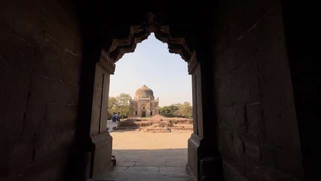 Exploring Ancient Indian Tomb Through Ornate Stone Archway