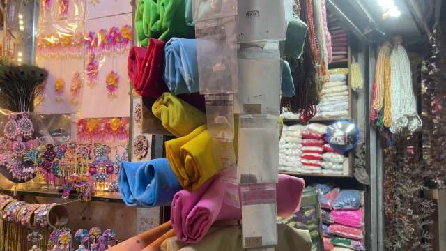 Colorful Fabric Rolls and Embellishments at Local Market Stall