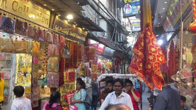 Bustling Market Street in Delhi Showcasing Traditional Indian Fabrics