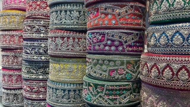 Colorful Rolls of Ornate Embroidered Ribbon on Display
