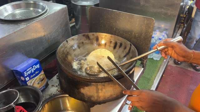 Street Vendor Deep Fries Fresh Indian Bread in Ghee
