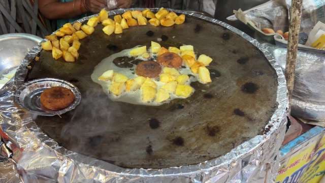 Street Vendor Frying Aloo Tikki and Potatoes in India