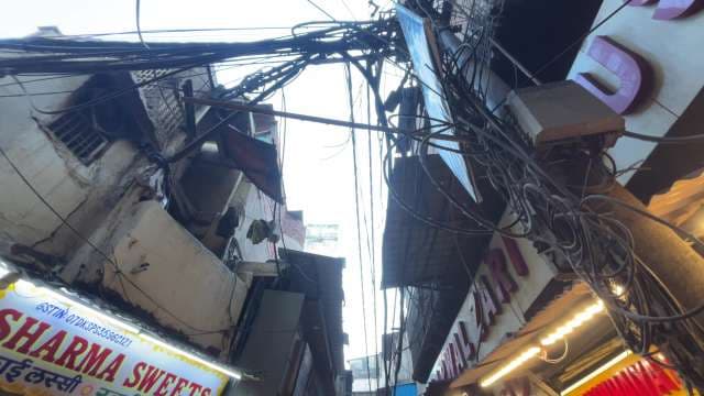 Tangled Overhead Wires in Crowded Urban Street Scene