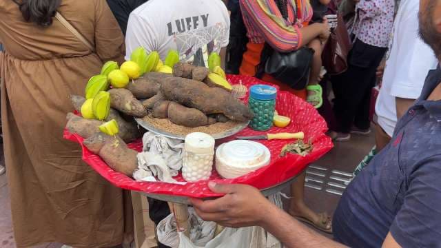 Traditional Indian Street Vendor Serving Roasted Sweet Potatoes