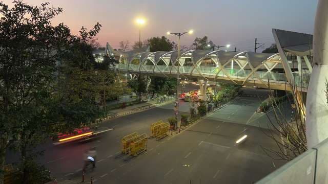 Modern Pedestrian Bridge Illuminated at Dusk in Urban City