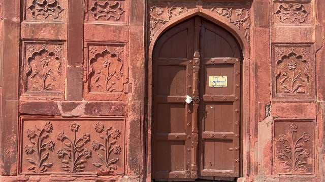 Historic Red Sandstone Door With Intricate Floral Carvings