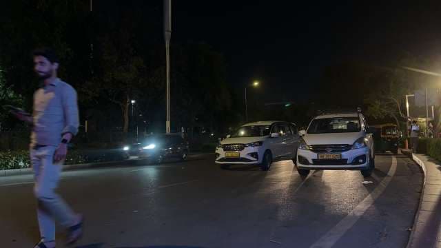 Nighttime City Street with Cars and Pedestrians