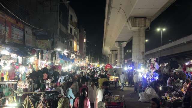 Bustling Night Market in Delhi Under Metro Line