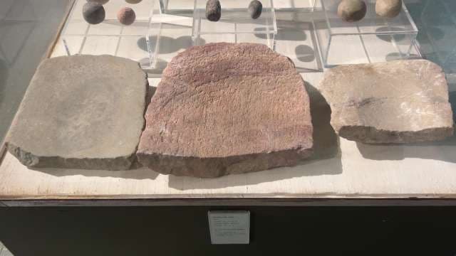 Ancient Grinding Stones Displayed in Museum Exhibit