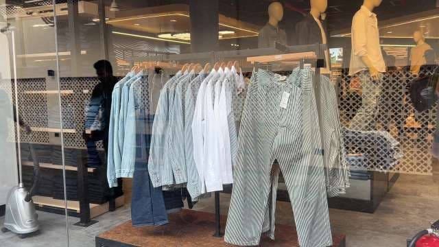 Trendy Striped Shirts and Jeans Displayed in Fashion Store Window