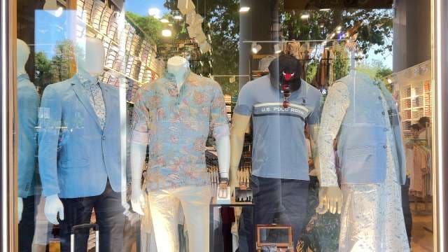 Trendy Men's Outfits Displayed in Fashion Store Window