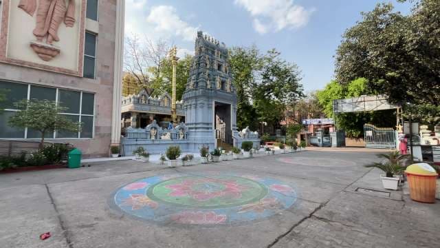 Serene Hindu Temple Courtyard with Rangoli Art