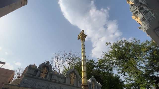 Golden Pillar at Rangji Temple in Mathura Under Blue Sky