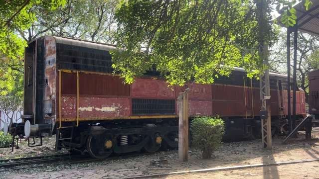 Rusty Abandoned Train Car in Sunlit Railway Museum
