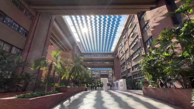 Modern Atrium With Glass Ceiling and Lush Greenery