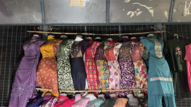 Colorful Traditional Dresses Displayed in Market Stall