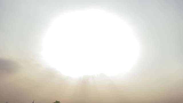 Blazing Sunburst Shines Over Hazy Landscape