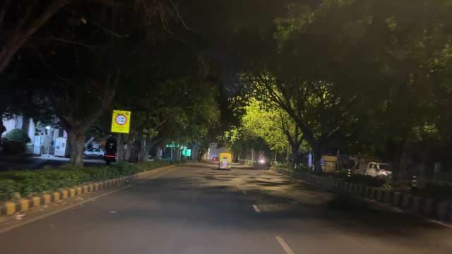 Auto Rickshaw Drives Through Quiet Indian Street at Night