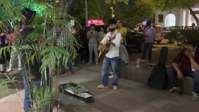 Street Musician Performs Live in Connaught Place at Night