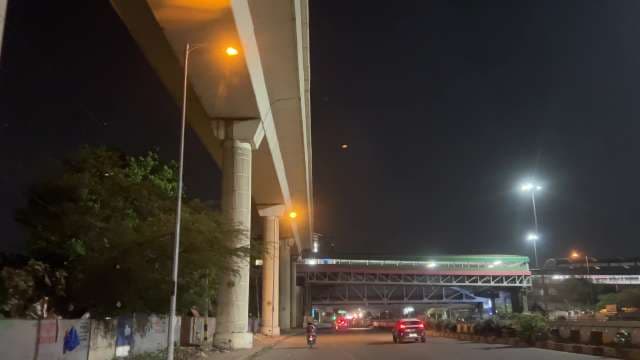 Night City Road Under Overpass with Traffic Lights