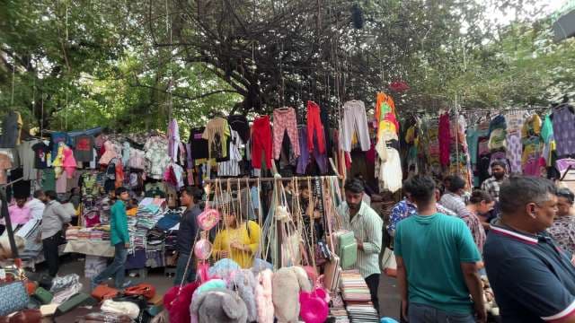 Bustling Street Market With Clothes, Accessories, and Shoppers