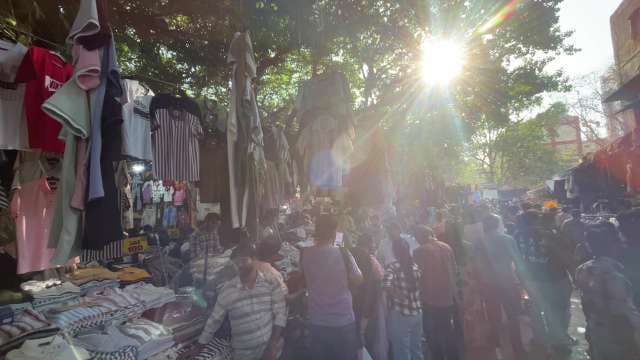 Busy Street Market with Clothing Stalls and Shoppers