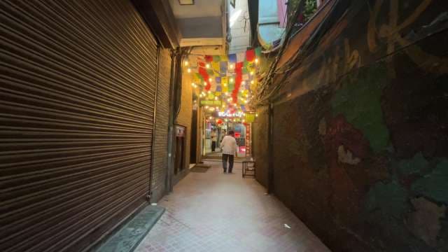 Colorful Alleyway With Lights and Flags in Urban City