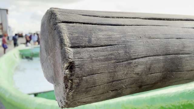 Close-Up of Weathered Wooden Oar by Fishing Boat