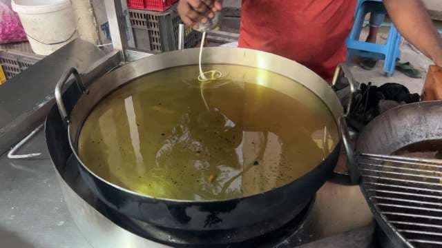 Street Vendor Deep Frying Batter for Crispy Jalebi