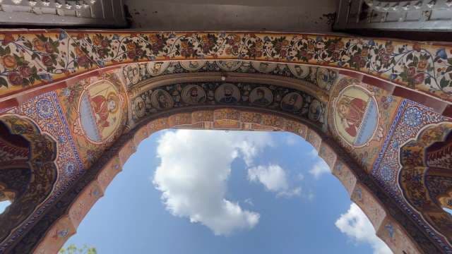 Intricate Mughal Floral Archway Against Blue Sky