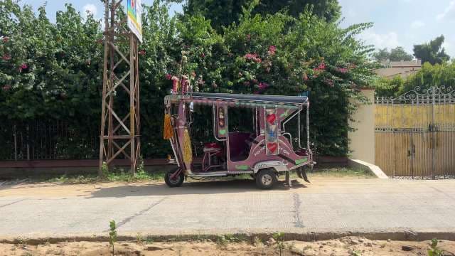 Vibrantly Decorated Rickshaw on Indian Street in Daylight