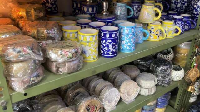Colorful Handcrafted Ceramic Mugs and Coasters Displayed in Shop