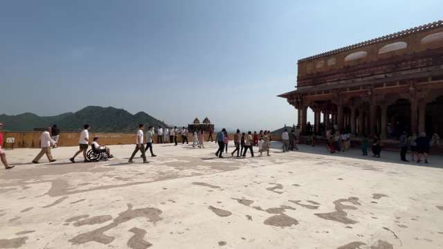 Tourists Explore the Courtyard of Amber Fort in Jaipur