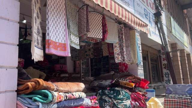Traditional Textile Shop Showcasing Colorful Fabric and Blankets
