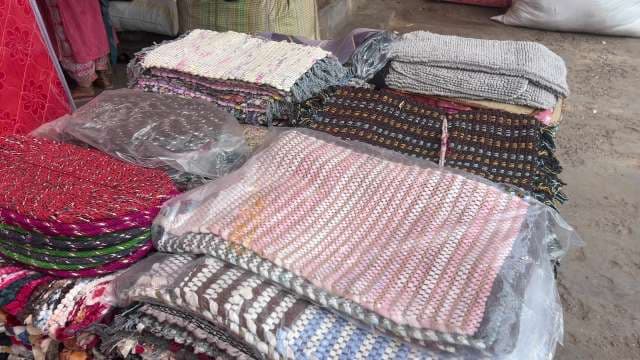 Colorful Handmade Rugs Displayed at Local Market Stall