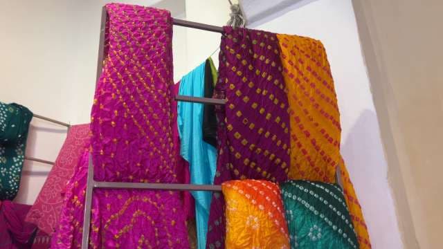 Vibrant Bandhani Fabrics Displayed in Traditional Indian Shop