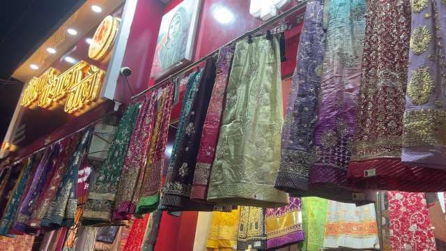 Vibrant Traditional Indian Sarees Displayed at Night Market