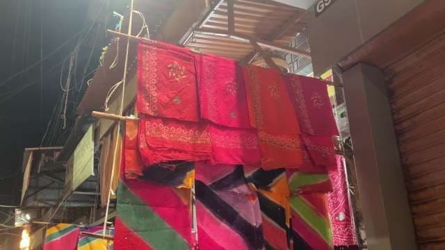 Vibrant Indian Saree Display at Local Night Market